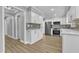 Modern kitchen with white cabinets, stainless steel appliances and gray backsplash at 1006 Sedwick W Rd, Durham, NC 27713