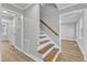 Modern staircase with wooden steps and a gray wall, leading to the upper floor at 1006 Sedwick W Rd, Durham, NC 27713