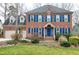 Charming brick home featuring a well-manicured lawn and contrasting blue shutters at 103 Sandy Hook Way, Cary, NC 27513