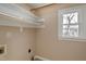 Laundry room with shelving and window, providing natural light at 103 Sandy Hook Way, Cary, NC 27513