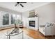 Living room with hardwood floors, fireplace, and large windows at 103 Sandy Hook Way, Cary, NC 27513