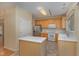 Kitchen with light wood cabinets, island, and appliances at 1031 Lake Moraine Pl, Raleigh, NC 27607