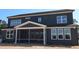 Back exterior view of a two-story home with a covered screened-in porch at 1104 Opal Ln # 104, Durham, NC 27705