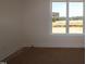 Bright bedroom featuring neutral walls, carpeted floors, and windows providing ample natural light at 1104 Opal Ln # 104, Durham, NC 27705