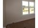 Bright bedroom featuring neutral walls, carpeted floors, and windows providing ample natural light at 1104 Opal Ln # 104, Durham, NC 27705