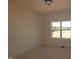 Bright bedroom featuring neutral walls and a large window offering outside views at 1104 Opal Ln # 104, Durham, NC 27705