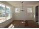 Spacious dining room with modern lighting and large windows providing ample natural light at 1104 Opal Ln # 104, Durham, NC 27705