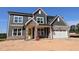 New two-story home with stone and siding details and a two-car garage at 1104 Opal Ln # 104, Durham, NC 27705