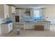 Bright, modern kitchen with white cabinets, a large island, and ample counter space awaiting finishing touches at 1104 Opal Ln # 104, Durham, NC 27705