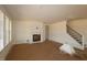 Spacious living room featuring a fireplace and staircase ready for customization at 1104 Opal Ln # 104, Durham, NC 27705