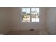 Bright bedroom with a large window overlooking a construction site and future homes at 1109 Opal Ln # 71, Durham, NC 27705