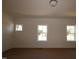 Bright bedroom featuring white walls, trim, and multiple windows providing natural light at 1109 Opal Ln # 71, Durham, NC 27705