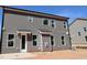 Rear exterior view showcasing gray siding and natural light from multiple windows at 1109 Opal Ln # 71, Durham, NC 27705