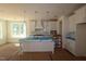 Bright, open kitchen with a large island, modern lighting, and white cabinetry at 1109 Opal Ln # 71, Durham, NC 27705