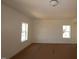 Well-lit living room with white walls, trim, and multiple windows, perfect for a cozy atmosphere at 1109 Opal Ln # 71, Durham, NC 27705