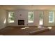 Living room featuring a cozy fireplace, bright windows, and neutral walls at 1109 Opal Ln # 71, Durham, NC 27705