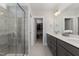 Double vanity bathroom with gray cabinets, quartz countertops and a walk-in shower at 1141 Logperch Way, Wendell, NC 27591