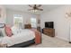 Spacious bedroom with a queen bed, dresser and ceiling fan at 1141 Logperch Way, Wendell, NC 27591