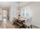 Farmhouse dining room with wooden table, bench, and chandelier at 1141 Logperch Way, Wendell, NC 27591