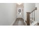 Hardwood floor entryway with staircase and white door at 1141 Logperch Way, Wendell, NC 27591