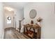 Bright and airy entryway with hardwood floors and a wooden console table at 1141 Logperch Way, Wendell, NC 27591
