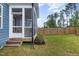 Home exterior showcasing a screened porch and backyard at 1141 Logperch Way, Wendell, NC 27591