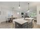 Modern kitchen with island, stainless steel sink, and gray cabinets at 1141 Logperch Way, Wendell, NC 27591