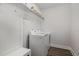 Bright laundry room with washer, dryer, and built-in shelving at 1141 Logperch Way, Wendell, NC 27591