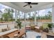 Relaxing screened porch with wooden furniture and a view of the backyard at 1141 Logperch Way, Wendell, NC 27591