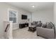 Cozy sitting area with gray couches and a dark wood coffee table at 1141 Logperch Way, Wendell, NC 27591