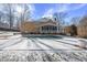 House with inground pool and screened porch, snow covered at 12016 Pembridge Ln, Raleigh, NC 27613