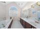 Bright bathroom features double sinks, large mirror, garden tub, and a window that allows natural light to flood the room at 12016 Pembridge Ln, Raleigh, NC 27613