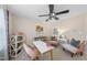 This bedroom is decorated with a desk, chairs, a large window, and bookshelves for creating a workspace at 12016 Pembridge Ln, Raleigh, NC 27613