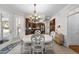 Bright dining room with a white table and four chairs at 12016 Pembridge Ln, Raleigh, NC 27613