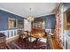 Formal dining room with dark blue walls and wood furniture at 12016 Pembridge Ln, Raleigh, NC 27613