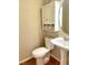 Half bathroom featuring a pedestal sink and a decorative mirror with a shelf and storage at 121 Gratiot Dr, Morrisville, NC 27560