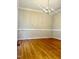 Dining room featuring hardwood floors and traditional chandelier, ideal for elegant dinners at 121 Gratiot Dr, Morrisville, NC 27560