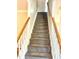 Carpeted staircase with white banisters and wooden handrails leading to the upper level of the home at 121 Gratiot Dr, Morrisville, NC 27560