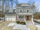 Two-story house with gray siding, white trim, and a brown front door at 1305 Whiston Dr, Apex, NC 27502