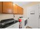 Laundry room with washer, dryer, and ample cabinet storage at 1305 Whiston Dr, Apex, NC 27502