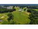Beautiful aerial shot of the property showcasing the luxury home, tree lined drive and sprawling green pastures at 14425 Nc-96 N Hwy, Zebulon, NC 27597