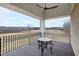 Balcony overlooking tranquil landscape; features metal table at 14425 Nc-96 N Hwy, Zebulon, NC 27597