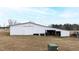 White barn with attached shed and tractor at 14425 Nc-96 N Hwy, Zebulon, NC 27597