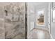 Modern bathroom with marble shower and large window at 14425 Nc-96 N Hwy, Zebulon, NC 27597
