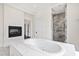 Spa-like bathroom with soaking tub, walk-in shower, and fireplace at 14425 Nc-96 N Hwy, Zebulon, NC 27597