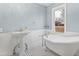 Elegant bathroom with a clawfoot tub and pedestal sink at 14425 Nc-96 N Hwy, Zebulon, NC 27597
