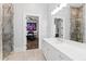 Bright bathroom featuring a large vanity, marble details, walk-in shower, and a glimpse into the bedroom at 14425 Nc-96 N Hwy, Zebulon, NC 27597
