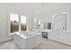Bright bathroom features a soaking tub with marble surround, vanity, and views from a large window at 14425 Nc-96 N Hwy, Zebulon, NC 27597