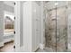 Bathroom with a glass-enclosed shower and linen cabinet at 14425 Nc-96 N Hwy, Zebulon, NC 27597