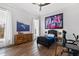 Bedroom with wood floors, large art and a workspace at 14425 Nc-96 N Hwy, Zebulon, NC 27597